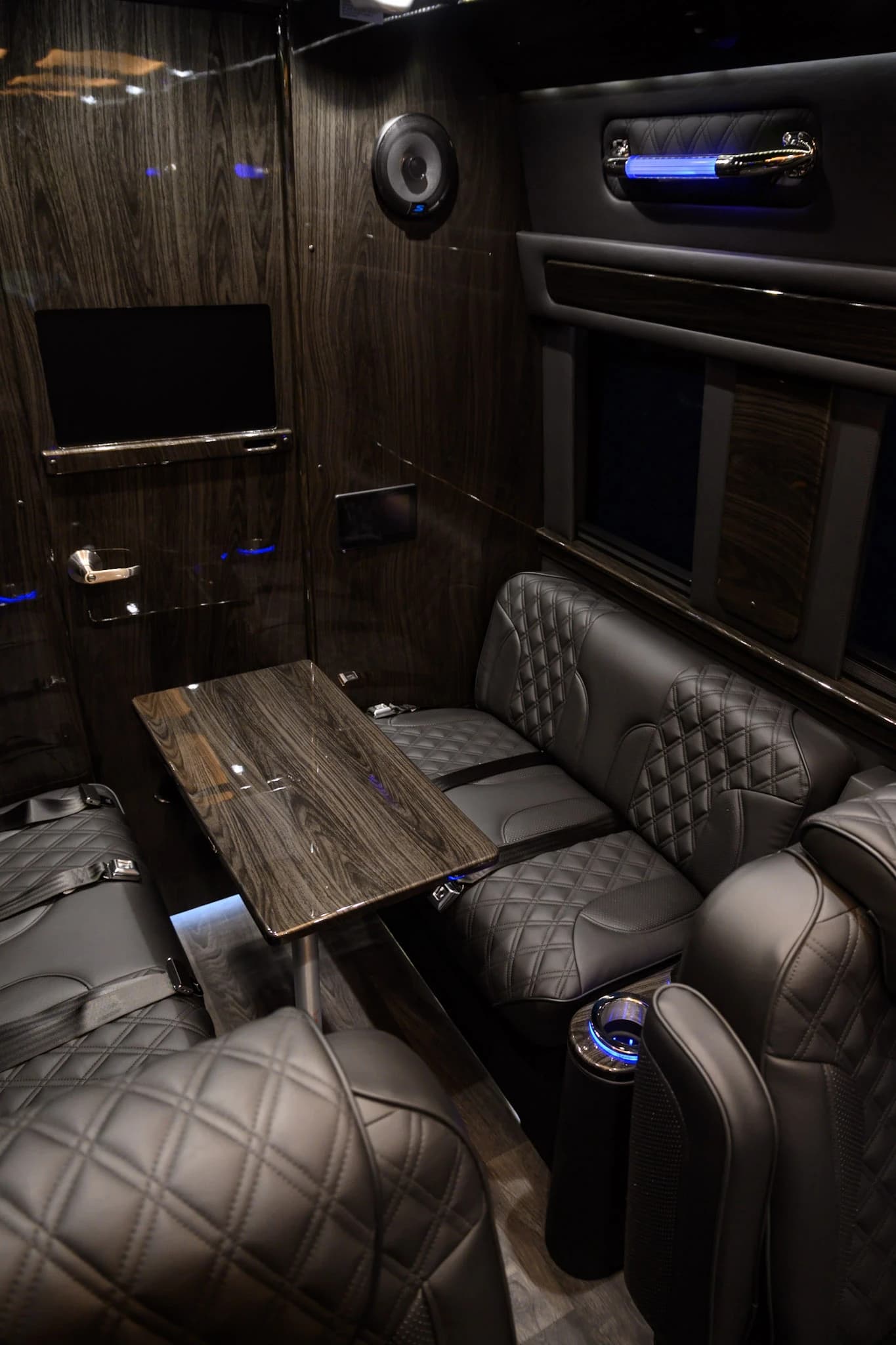 Conduct meetings on the road with our polished wood conference table — a first-class mobile office for corporate groups and executive transportation.