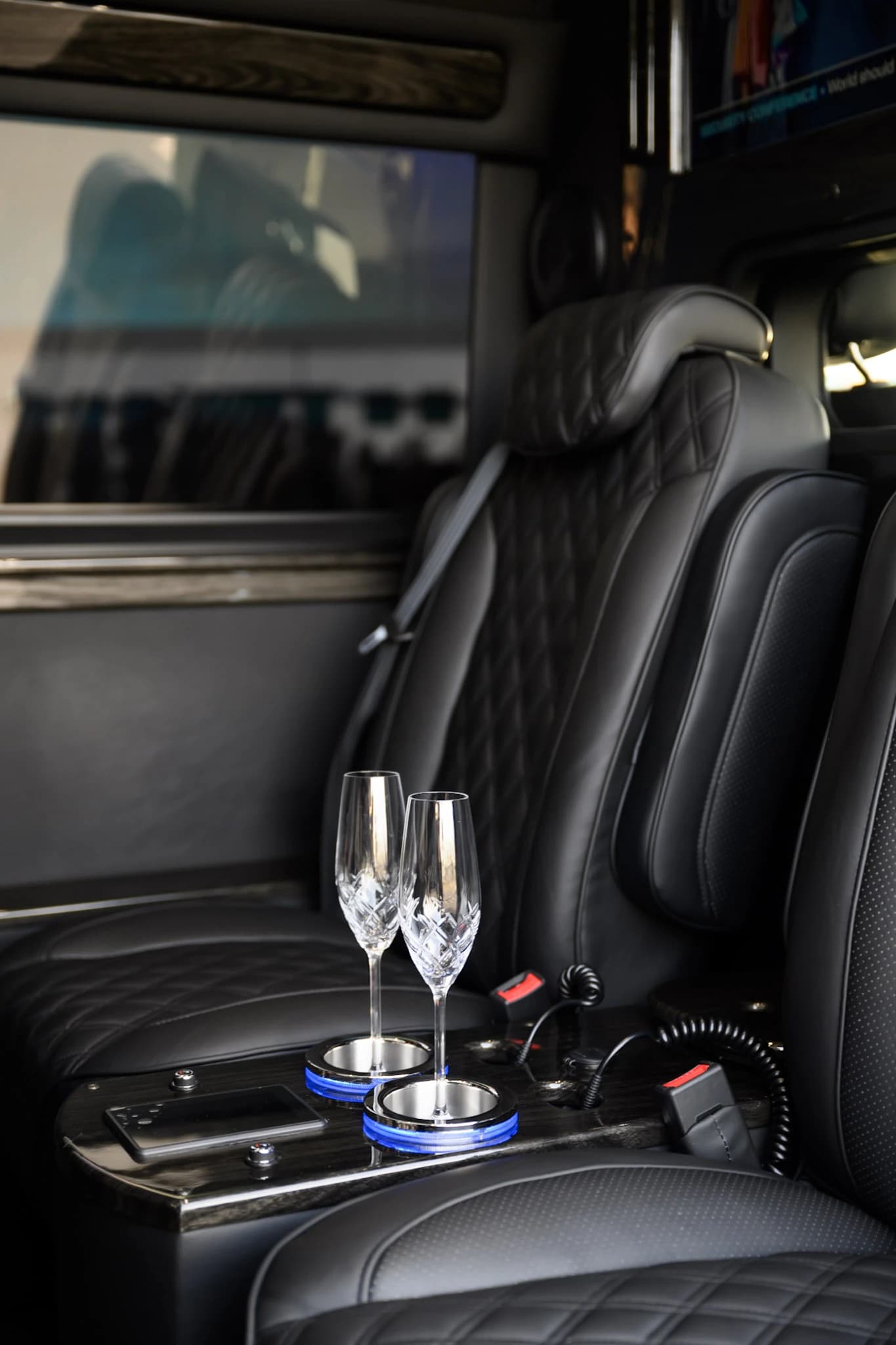 Keep drinks and controls within reach with a polished armrest console designed for comfortable private Sprinter travel.