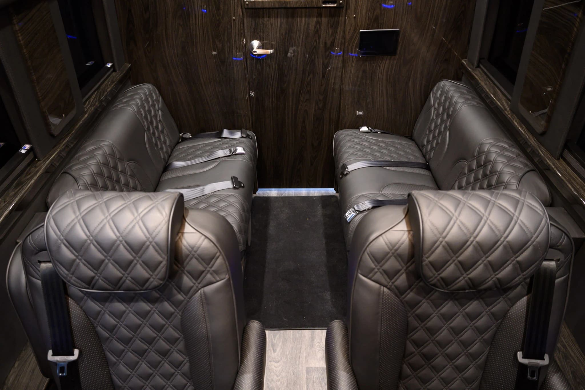 Move comfortably inside a private Sprinter cabin with an open walkway and spacious seating layout for group trips.